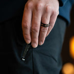 Man wearing "The Blaze" tungsten ring in black and rose gold putting his hand into his pants pocket