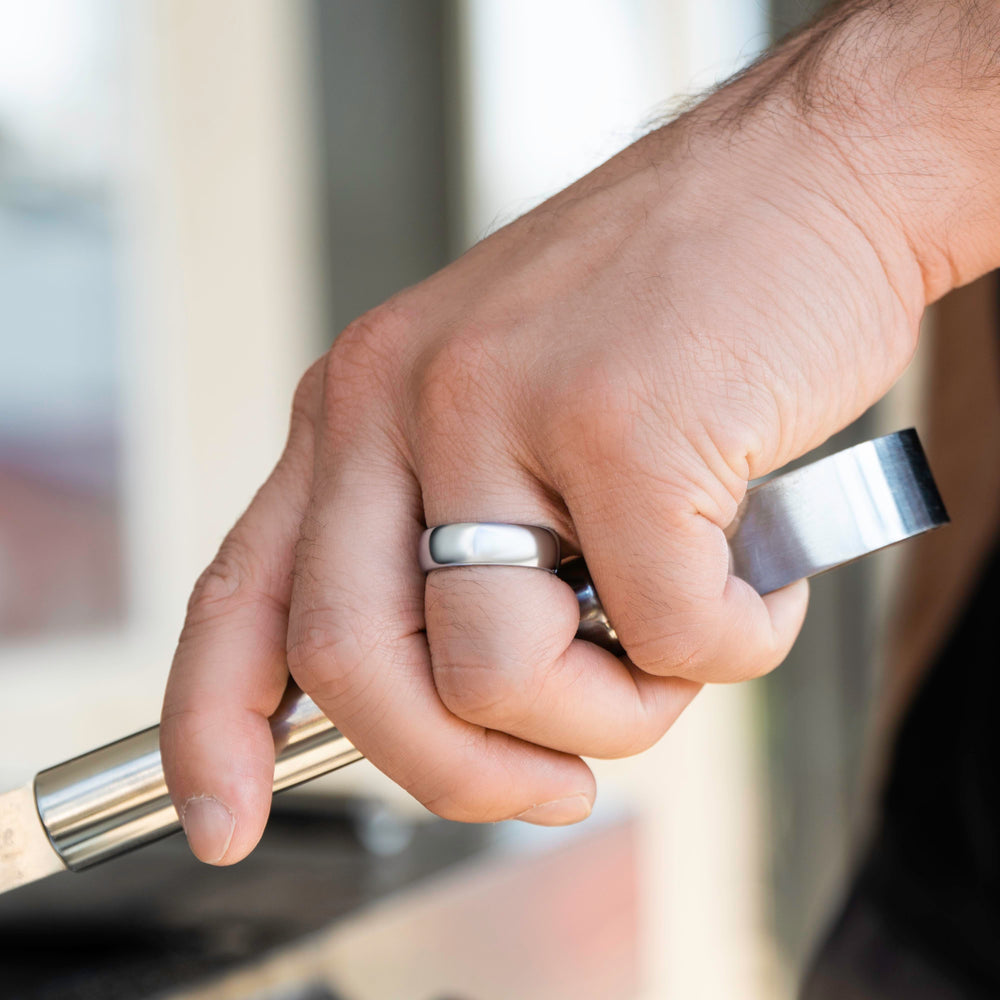 Man wearing "The Maverick" tungsten ring in polished silver using bbq tongs