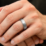 Macro close-up of The Gentleman brushed silver tungsten ring showing its finish and comfort-fit profile